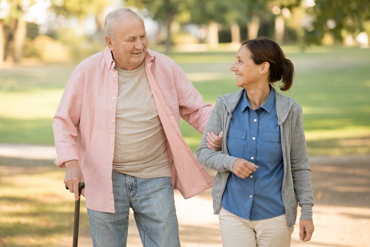 Senior couple walking hand in hand through a park in Shreveport, LA