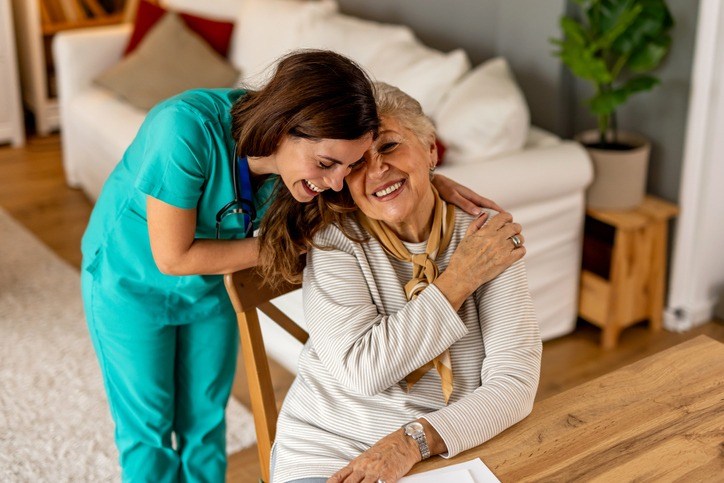 A nurse aids an elderly woman with paperwork in Shreveport, LA