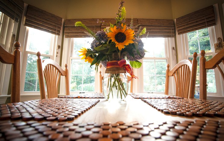 A flower vase is kept on a dining table in Shreveport, LA.