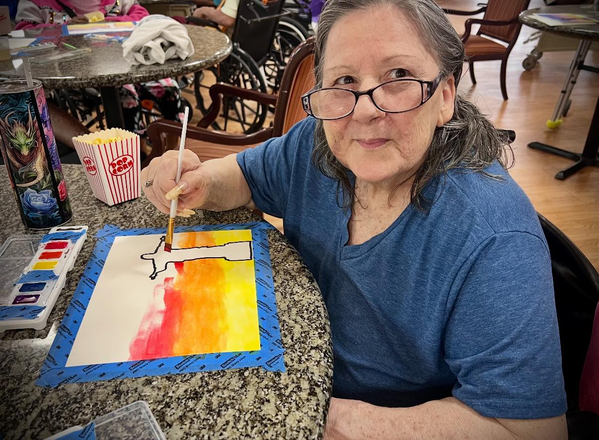 A resident painting during activities
