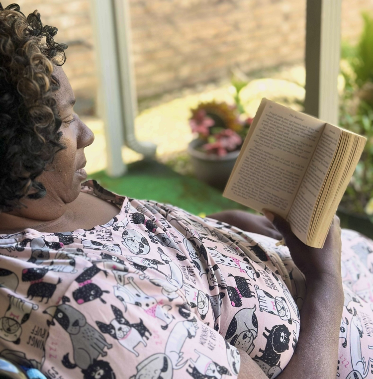 A resident relaxing with a book