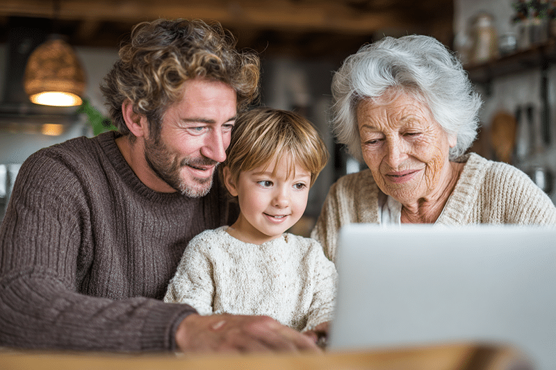 son and granddaughter with a grandmother at a laptop trying to decide what skilled nursing facility to go to