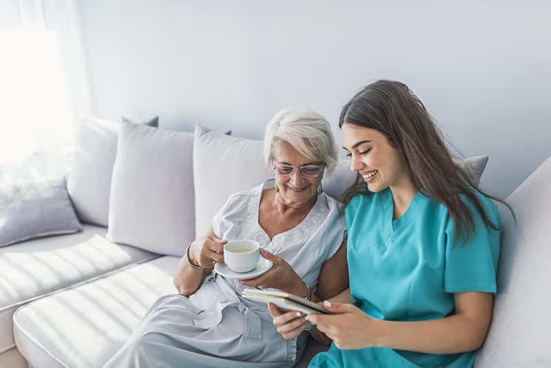 A nurse walking outdoors with a respite care resident