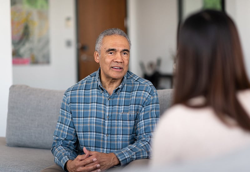 A senior man in a speech therapy session at a nursing facility