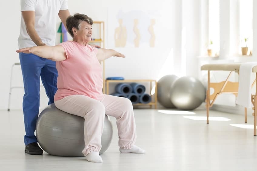 A therapist assisting a patient during short-term rehabilitation