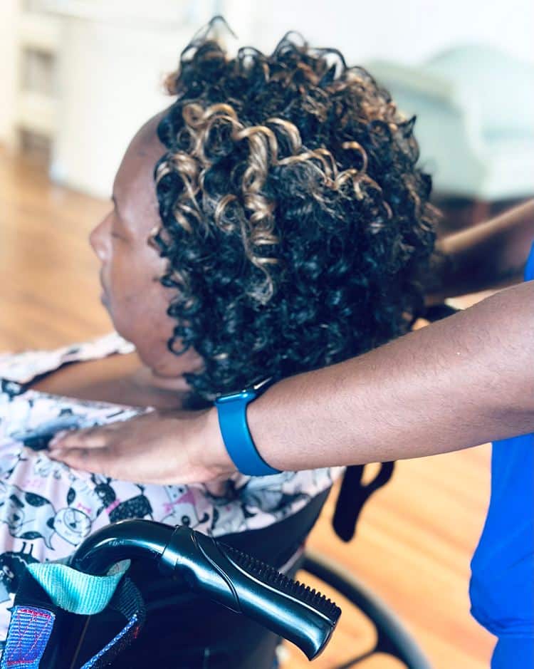 A woman in a wheelchair suffering from dementia, receiving long-term care at a nursing home